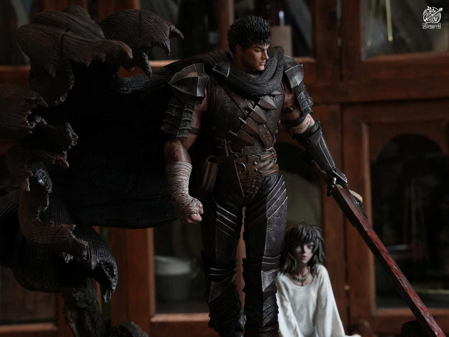 Berserk Guts Black Swordsman statue standing over seated Casca